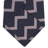 View 4 of product The Turnbull & Asser Navy and Rose Striped Zigzag Silk Tie features a bold zigzag pattern and is shown against a plain white background, making it an ideal accessory for the modern gentleman.