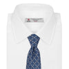 View 2 of product The Turnbull & Asser Blue Circle and Spot Silk Tie features a refined pattern of light blue and silver circles—ideal for pairing with an office shirt, elegantly displayed rolled on a plain white background.