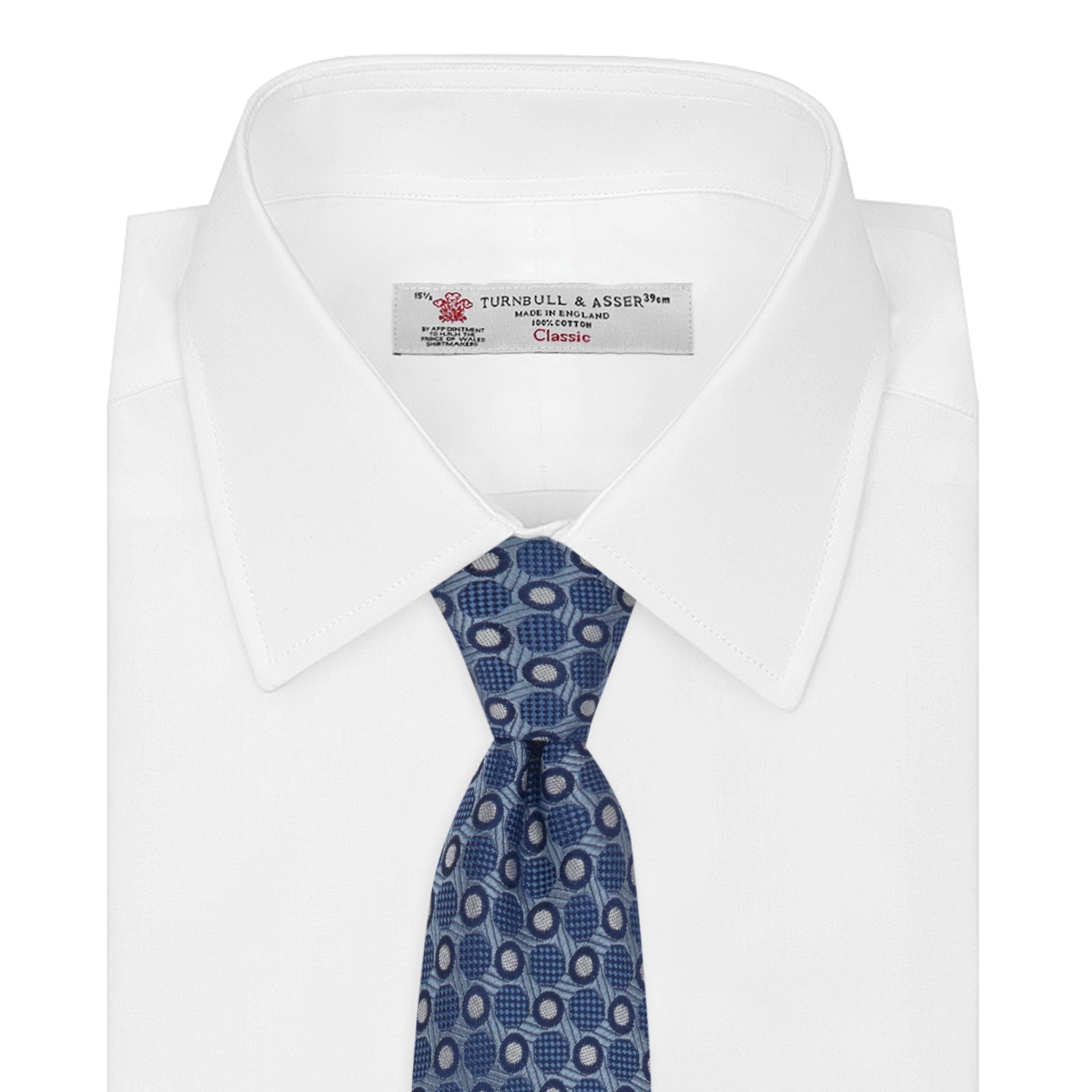 View 2 of product The Turnbull & Asser Blue Circle and Spot Silk Tie features a refined pattern of light blue and silver circles—ideal for pairing with an office shirt, elegantly displayed rolled on a plain white background.