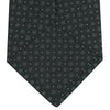 View 4 of product The Turnbull & Asser Forest Green Floral Spot Silk Tie features a subtle light gray circular pattern, shown rolled on a white background—a classic accessory ideal for office shirts.