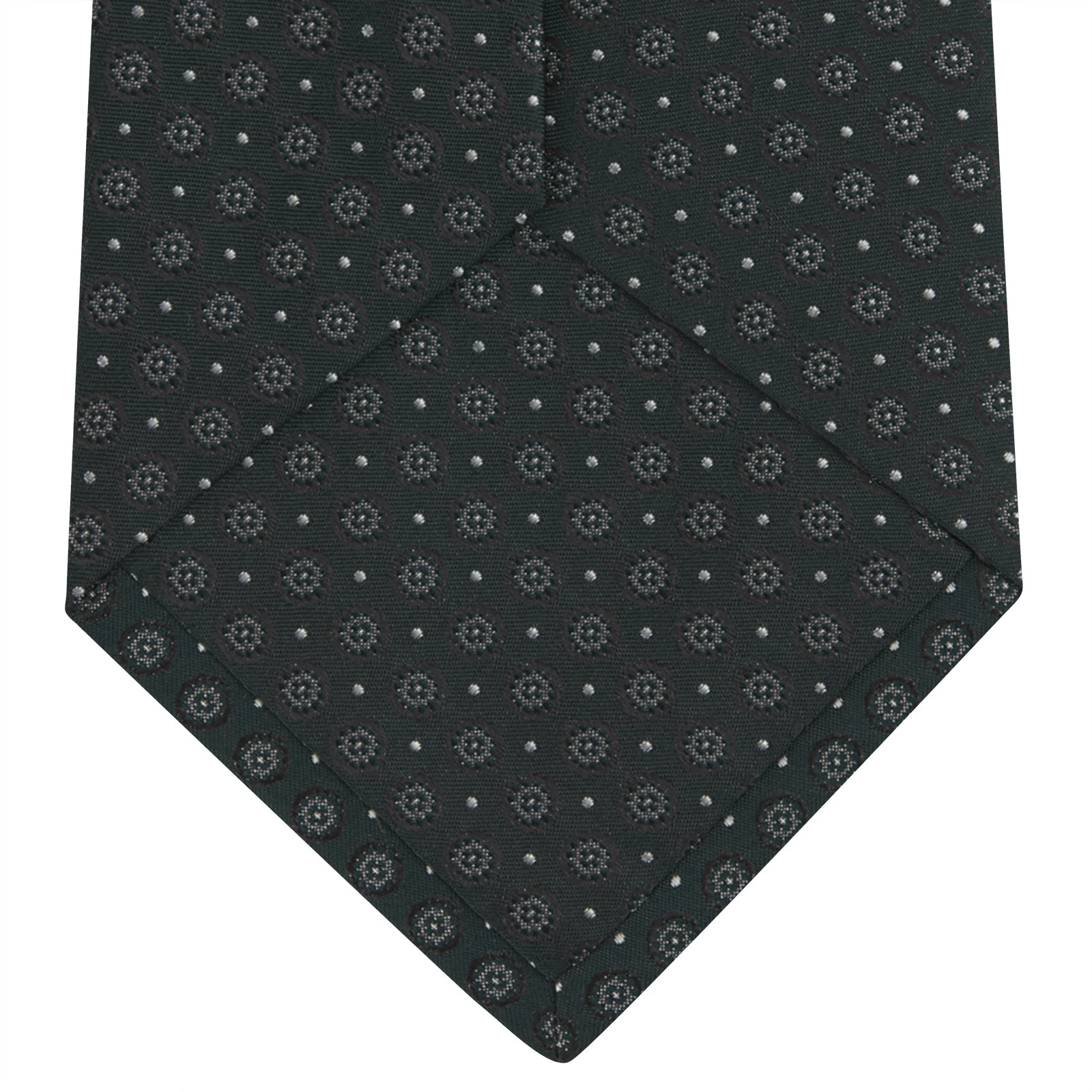 View 4 of product The Turnbull & Asser Forest Green Floral Spot Silk Tie features a subtle light gray circular pattern, shown rolled on a white background—a classic accessory ideal for office shirts.