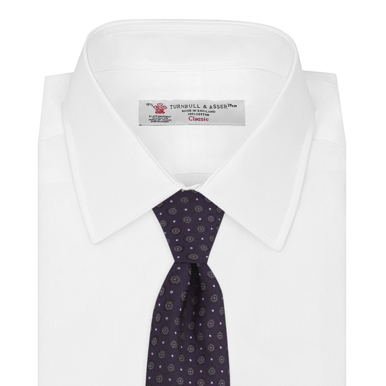View 2 of product The Turnbull & Asser Plum Floral Spot Silk Tie features a rolled-up classic design with small, evenly spaced floral spots in lighter purple and white, ideal for office shirts and shown against a plain white background.