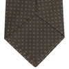 View 4 of product The Brown Floral Spot Silk Tie by Turnbull & Asser features a classic brown base with silver-gray floral spots—an elegant accessory that pairs perfectly with your office shirts.