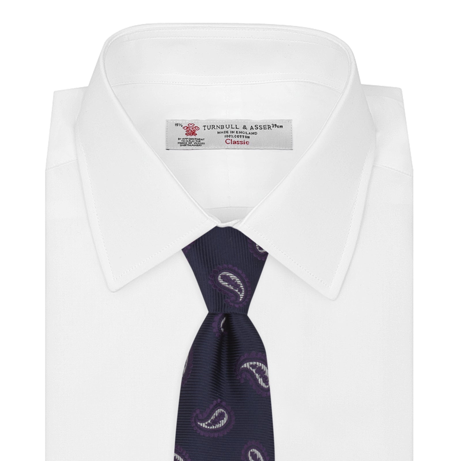 View 2 of product The Turnbull & Asser Navy and Plum Floating Paisley Silk Tie features a repeating purple and white paisley pattern, elegantly rolled up on a white background.