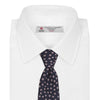 View 2 of product The Turnbull & Asser Navy and Pink Paint Spot Silk Tie, rolled at one end and set against a white background, adds a stylish touch to any office shirt with its modern spot pattern.