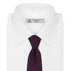 View 2 of product The Navy and Red Petal Paisley Silk Tie by Turnbull & Asser features an elegant paisley pattern on navy silk, rolled at one end and displayed on a plain white background.