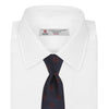 View 2 of product The Turnbull & Asser Navy and Burgundy Emblem Spot Silk Tie features a subtle textured pattern with small burgundy emblems on navy silk. Perfectly rolled with a pointed tip, it pairs well with any office shirt.