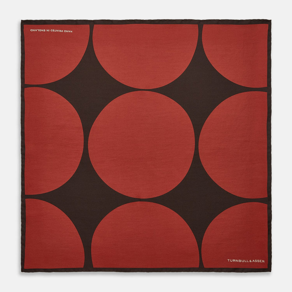 The DR. NO Red and Black Multi Spots Silk Pocket Square by Turnbull & Asser is handmade in England, featuring large red circles on black, with "Turnbull & Asser" and "Made in England" printed in white in the corners.