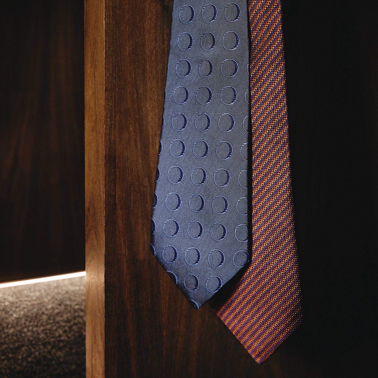 View 2 of product The Turnbull & Asser Die Another Day Circle Silk Tie, as seen on James Bond, features large dark blue ovals on a lighter blue background.