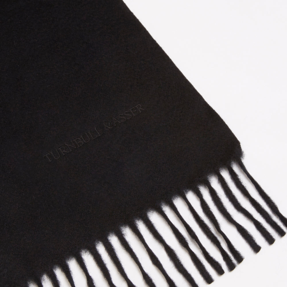 A Turnbull & Asser Black Pure Cashmere Scarf with fringe on both ends, neatly folded and displayed on a plain white background.