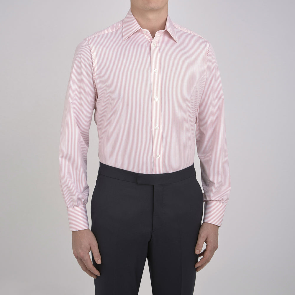 A neatly folded Turnbull & Asser blue shirt with a regent collar and 2-button cocktail cuffs, displayed against a plain white background.