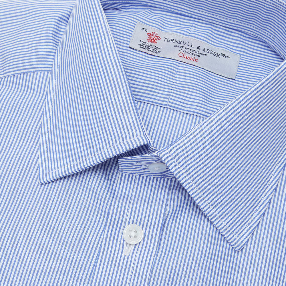 The Turnbull & Asser Blue Fine Bengal Stripe Shirt features a T&A collar, double cuffs, and white buttons, neatly folded and displayed against a plain white background.