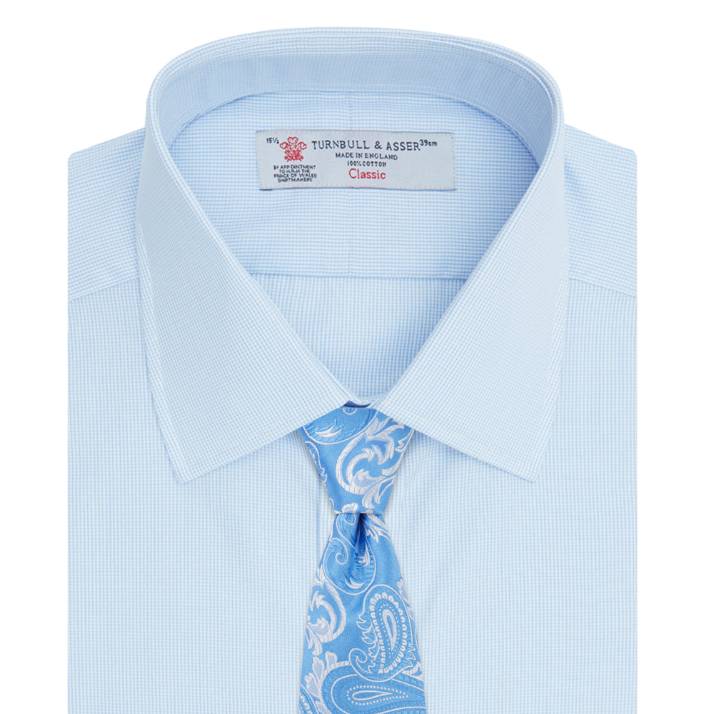Turnbull & Asser’s Light Blue Fine Check Shirt features a T&A collar, double cuffs, and a subtle checked cotton pattern, neatly displayed on a white background for a classic smart look.