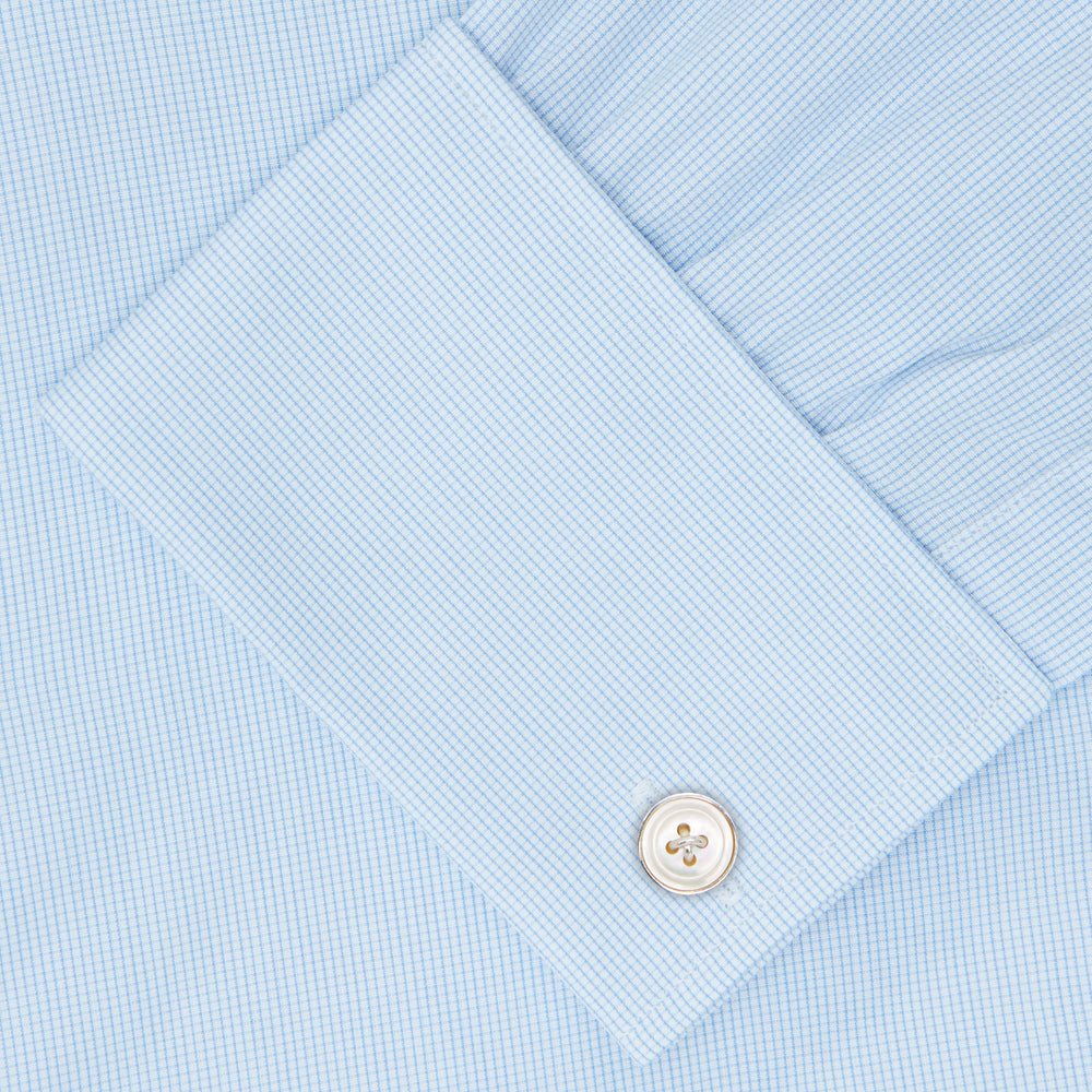 Turnbull & Asser’s Light Blue Fine Check Shirt features a T&A collar, double cuffs, and a subtle checked cotton pattern, neatly displayed on a white background for a classic smart look.
