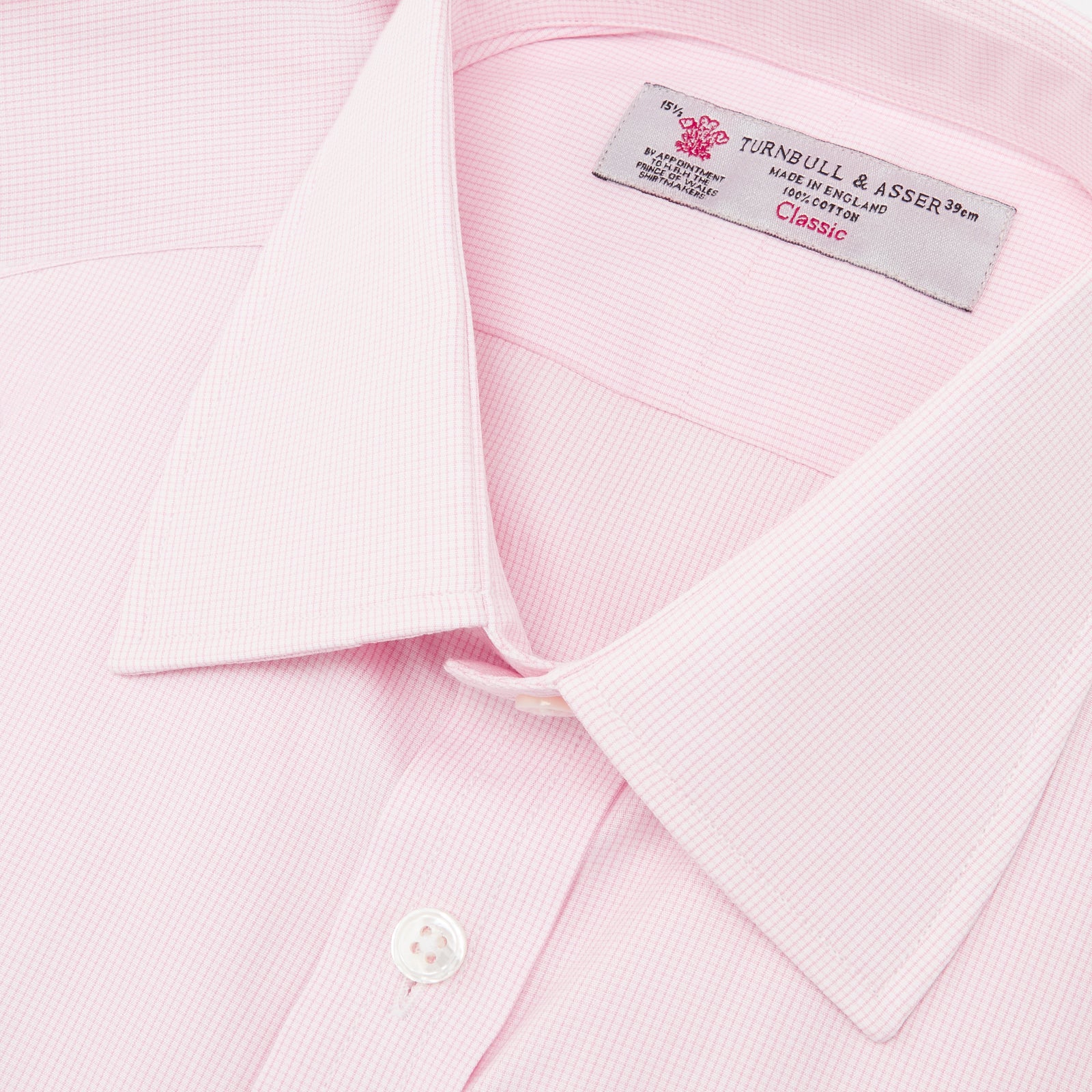 View 5 of product The Turnbull & Asser Pink Fine Check Shirt features a T&A collar, 3-button cuffs, and a subtle pink check design, made from fine cotton. Displayed neatly folded against a plain backdrop.