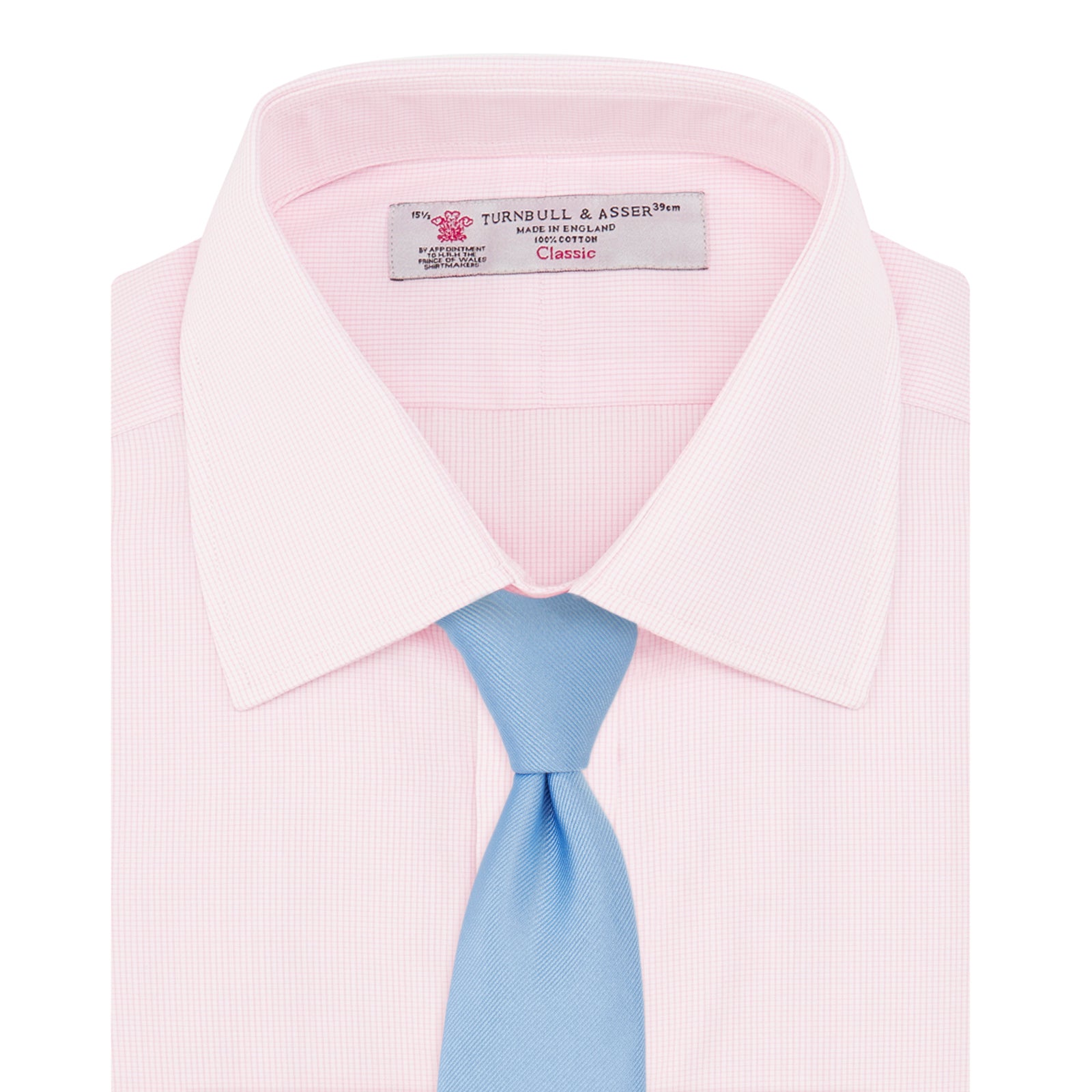 View 4 of product The Turnbull & Asser Pink Fine Check Shirt features a T&A collar, double cuffs, and classic white buttons, neatly folded and displayed against a plain white background.
