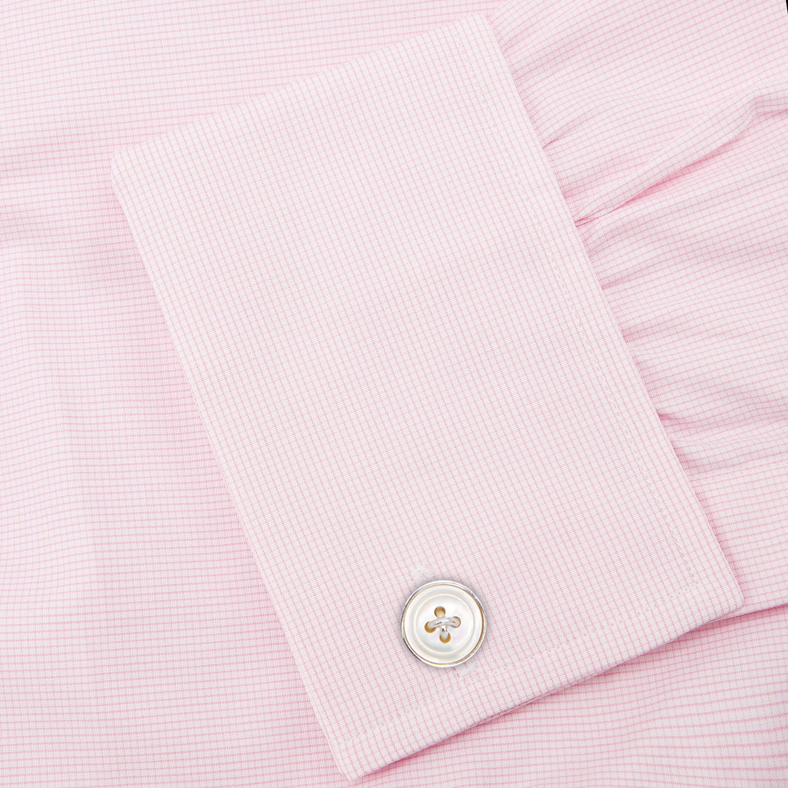 View 6 of product The Turnbull & Asser Pink Fine Check Shirt features a T&A collar, double cuffs, and classic white buttons, neatly folded and displayed against a plain white background.