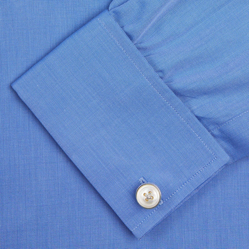 A neatly folded, dark blue end-on-end men's dress shirt by Turnbull & Asser, featuring a T&A collar and double cuffs, is displayed against a plain white background.