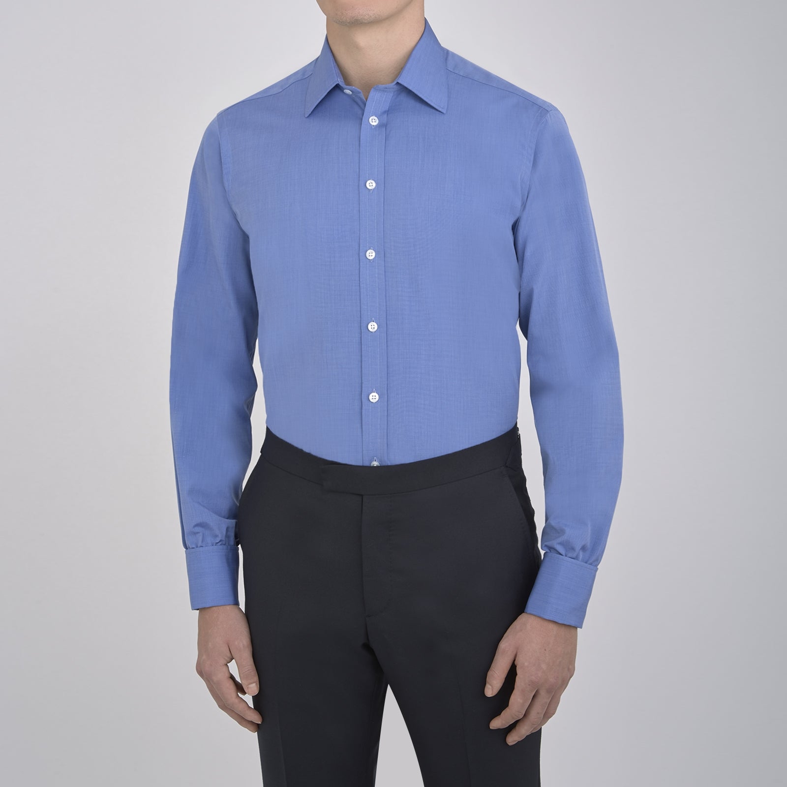 View 2 of product A neatly folded, dark blue end-on-end men's dress shirt by Turnbull & Asser, featuring a T&A collar and double cuffs, is displayed against a plain white background.