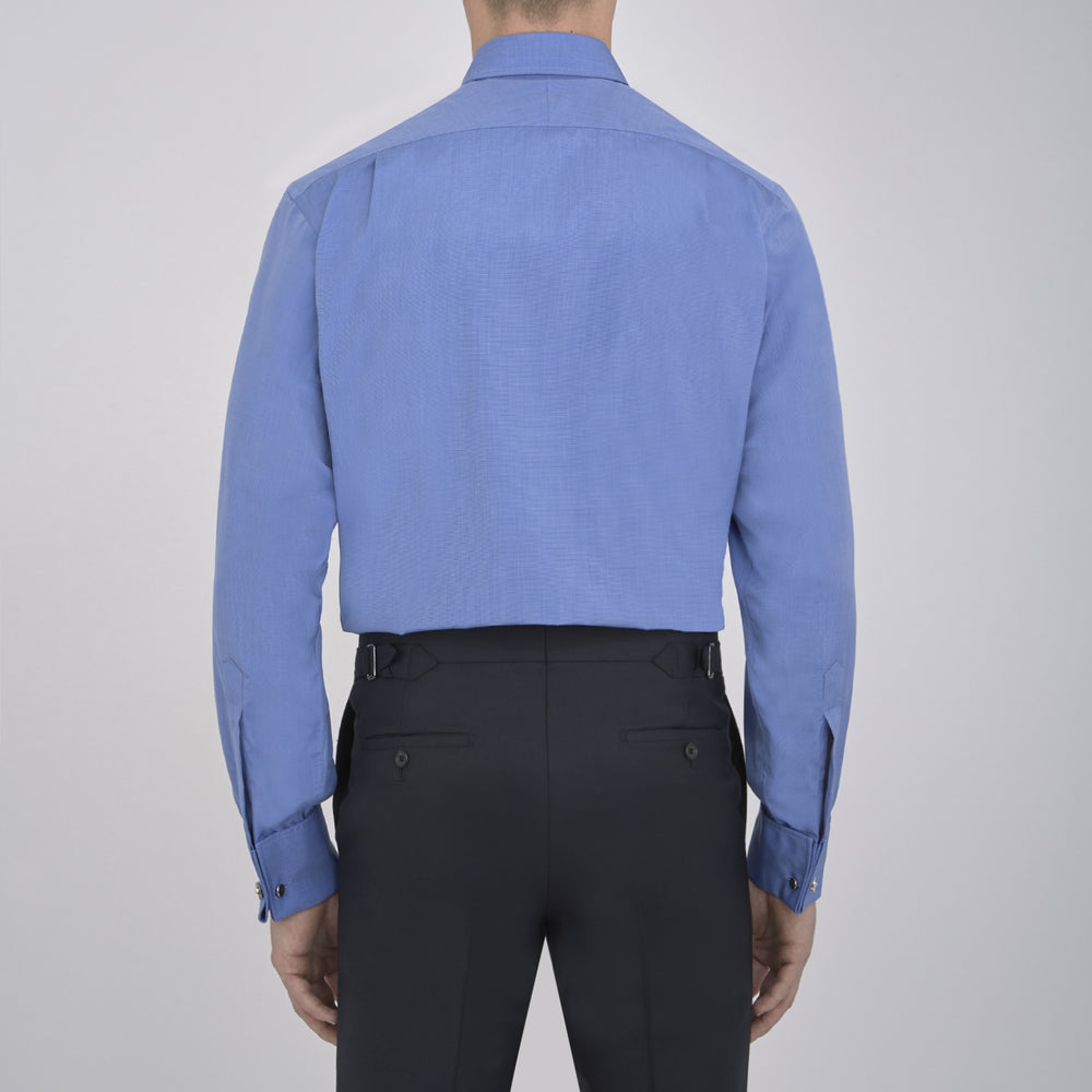 A neatly folded, dark blue end-on-end men's dress shirt by Turnbull & Asser, featuring a T&A collar and double cuffs, is displayed against a plain white background.