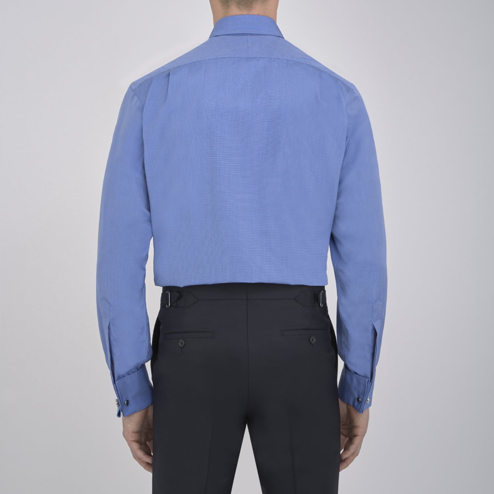 View 3 of product A neatly folded, dark blue end-on-end men's dress shirt by Turnbull & Asser, featuring a T&A collar and double cuffs, is displayed against a plain white background.