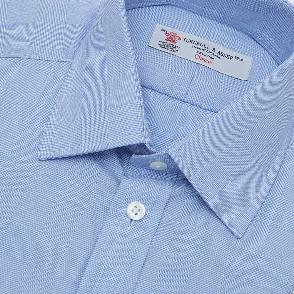 A Blue Prince of Wales Check Shirt by Turnbull & Asser, featuring a T&A collar and 3-button cuffs, is displayed against a plain white background.