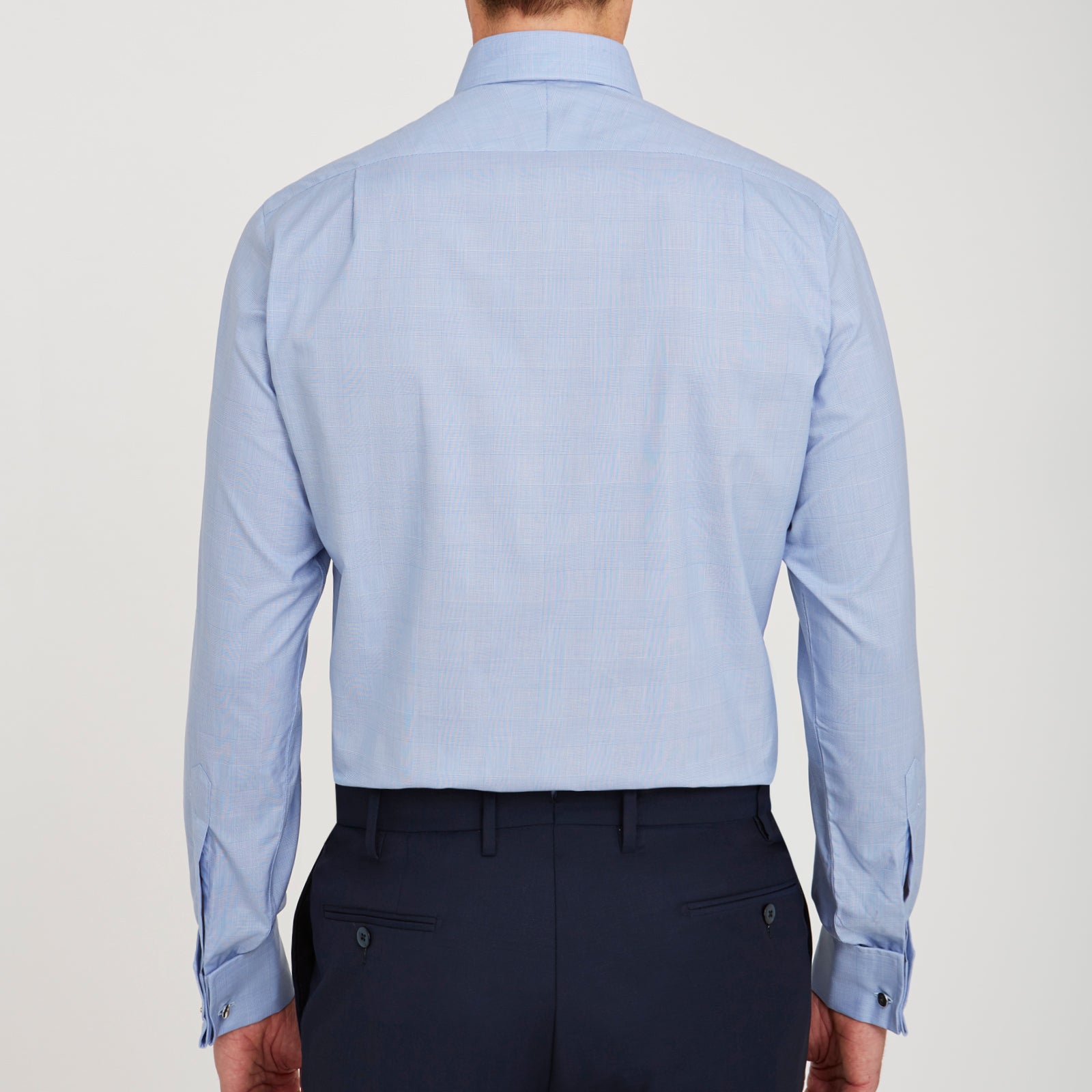 View 3 of product The Turnbull & Asser Blue Prince of Wales Check Shirt features a T&A collar and double cuffs, shown against a white background—ideal for timeless, minimalist style.