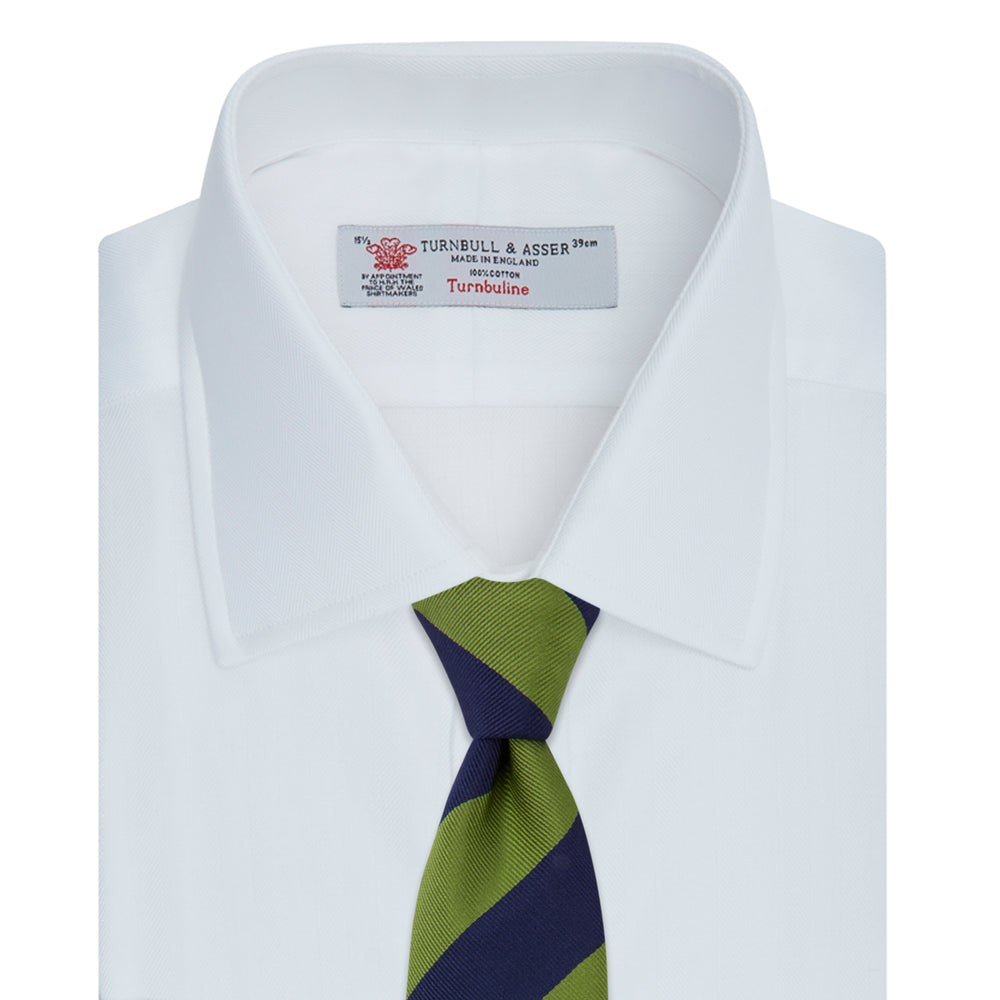 The Turnbull & Asser White Herringbone Superfine Cotton Shirt features a T&A collar and 3-button cuffs, displayed against a light blue background—ideal for minimalist styles or pairing with bold ties.