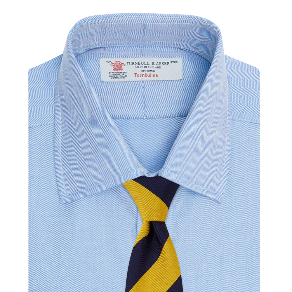 The Blue Herringbone Superfine Cotton Shirt by Turnbull & Asser features a T&A collar and 3-button cuffs, offering a refined minimalist look. Displayed against a plain white background.