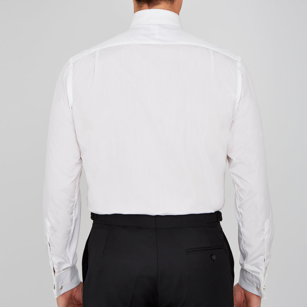 The Turnbull & Asser White Sea Island Quality Cotton Dress Shirt features a T&A collar and double cuffs, elegantly displayed on a light gray background.