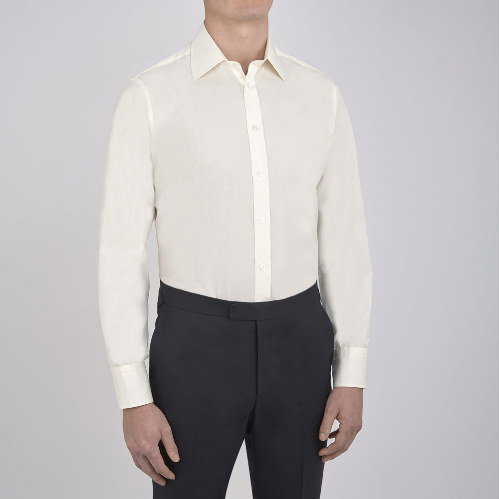 The Cream Sea Island Quality Cotton Shirt by Turnbull & Asser features a T&A collar and 3-button cuffs, crafted from premium cotton and displayed neatly folded against a plain white background.