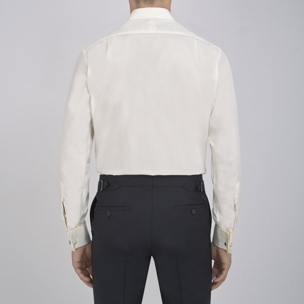 The Turnbull & Asser Cream Sea Island Quality Cotton Shirt features a T&A collar, double cuffs, and a button-down front, elegantly displayed against a white background.
