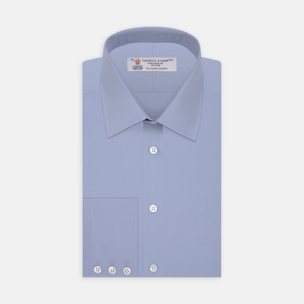 A pair of neatly folded light khaki pure cotton socks by Turnbull & Asser is displayed against a plain white background, their label visible and evoking the understated elegance typical of premium accessories.