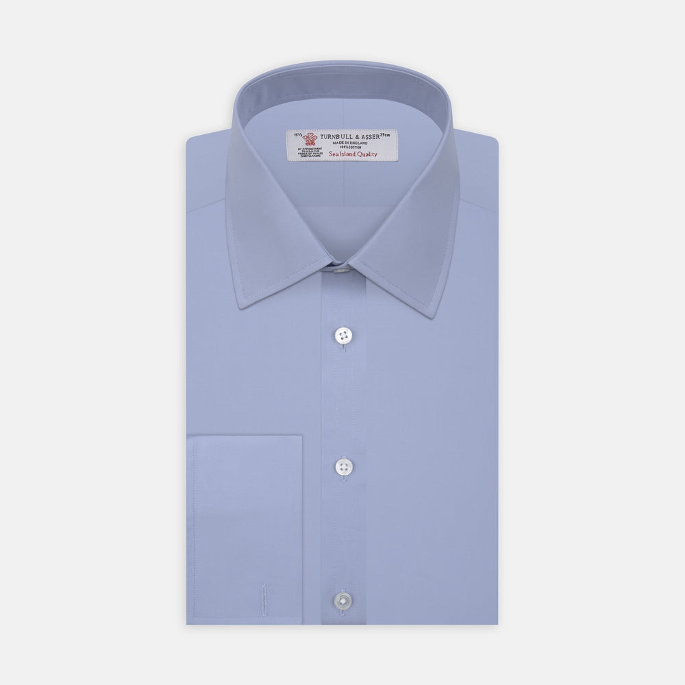 The Turnbull & Asser Blue Sea Island Quality Cotton Shirt features a T&A collar, double cuffs, and is showcased neatly folded on a plain white background.