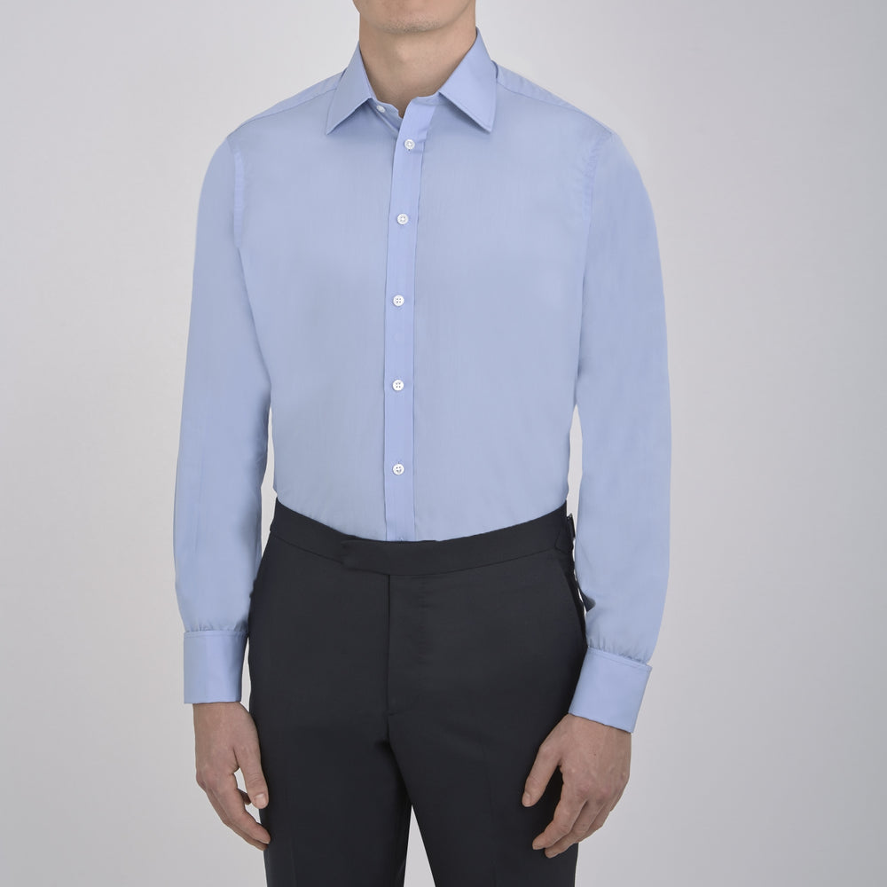 The Turnbull & Asser Blue Sea Island Quality Cotton Shirt features a T&A collar, double cuffs, and is showcased neatly folded on a plain white background.