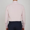 View 3 of product A slim black herringbone silk tie by Turnbull & Asser is paired with a neatly folded light pink long-sleeve dress shirt with a classic collar and white buttons, all displayed on a plain white background.