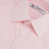 View 5 of product A slim black herringbone silk tie by Turnbull & Asser is paired with a neatly folded light pink long-sleeve dress shirt with a classic collar and white buttons, all displayed on a plain white background.
