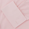 View 6 of product A slim black herringbone silk tie by Turnbull & Asser is paired with a neatly folded light pink long-sleeve dress shirt with a classic collar and white buttons, all displayed on a plain white background.