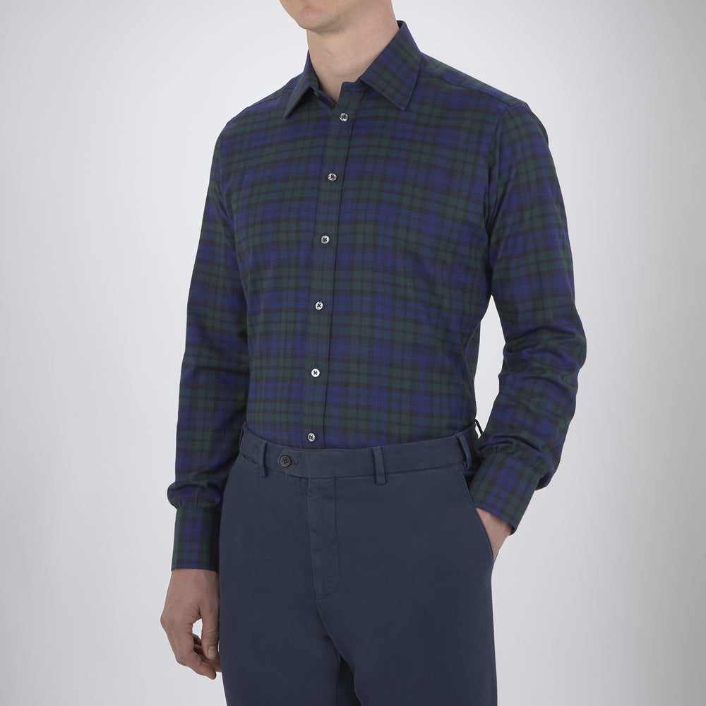 The Turnbull & Asser Blackwatch Brushed Cotton Shirt features a T&A collar, button cuffs, and a stylish dark blue and green plaid—perfect for any seasonal collection. Displayed here neatly folded on a plain white background.