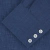View 2 of product The Turnbull & Asser Navy Linen Shirt features a T&A collar, long sleeves, and 3-button cuffs, making it a stylish summer essential. Displayed neatly folded against a plain white background.