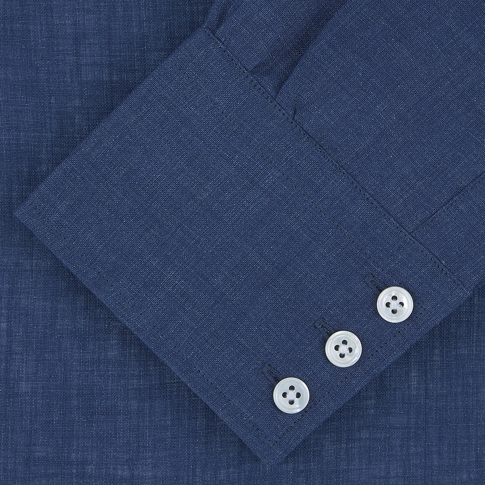 The Turnbull & Asser Navy Linen Shirt features a T&A collar, long sleeves, and 3-button cuffs, making it a stylish summer essential. Displayed neatly folded against a plain white background.