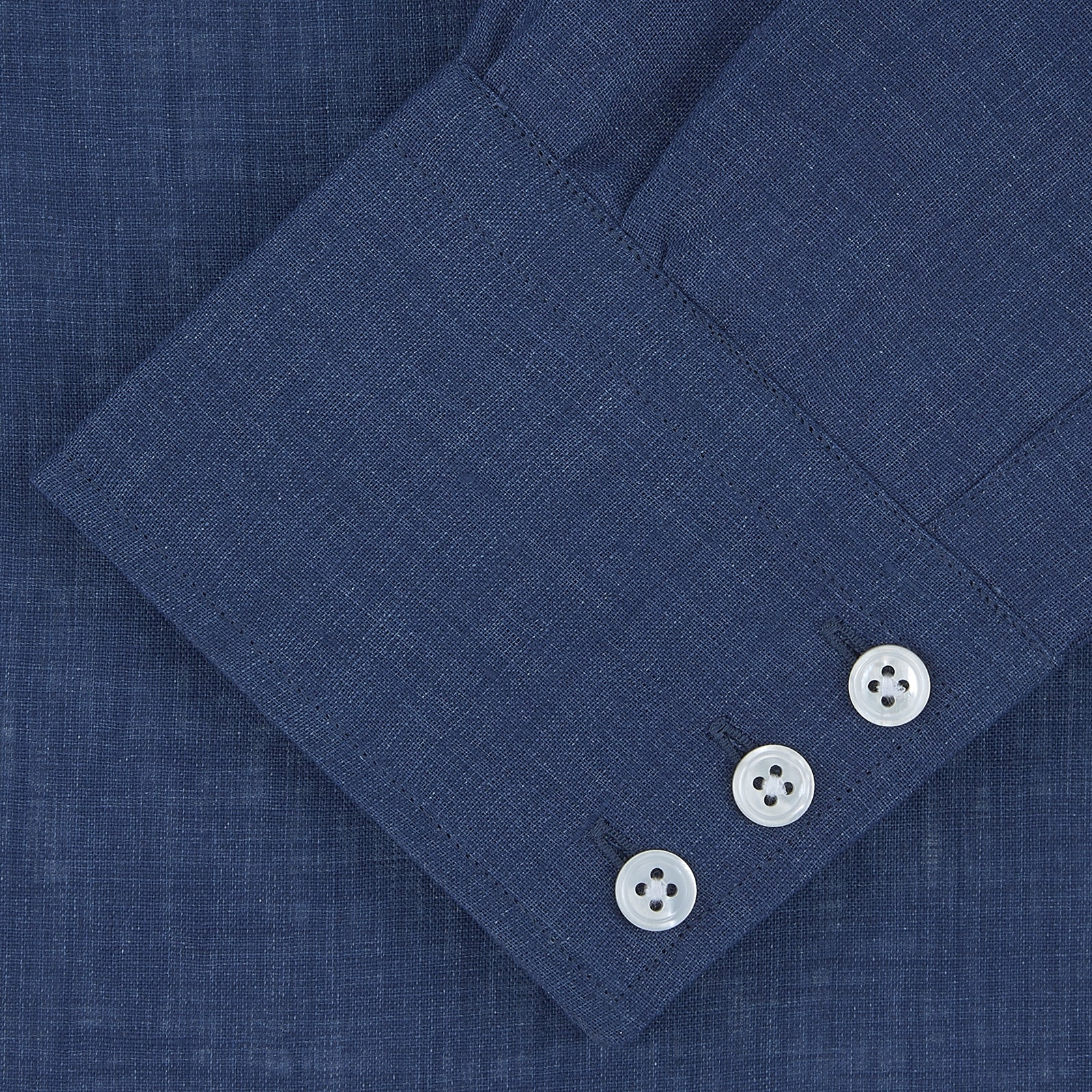 View 2 of product The Turnbull & Asser Navy Linen Shirt features a T&A collar, long sleeves, and 3-button cuffs, making it a stylish summer essential. Displayed neatly folded against a plain white background.