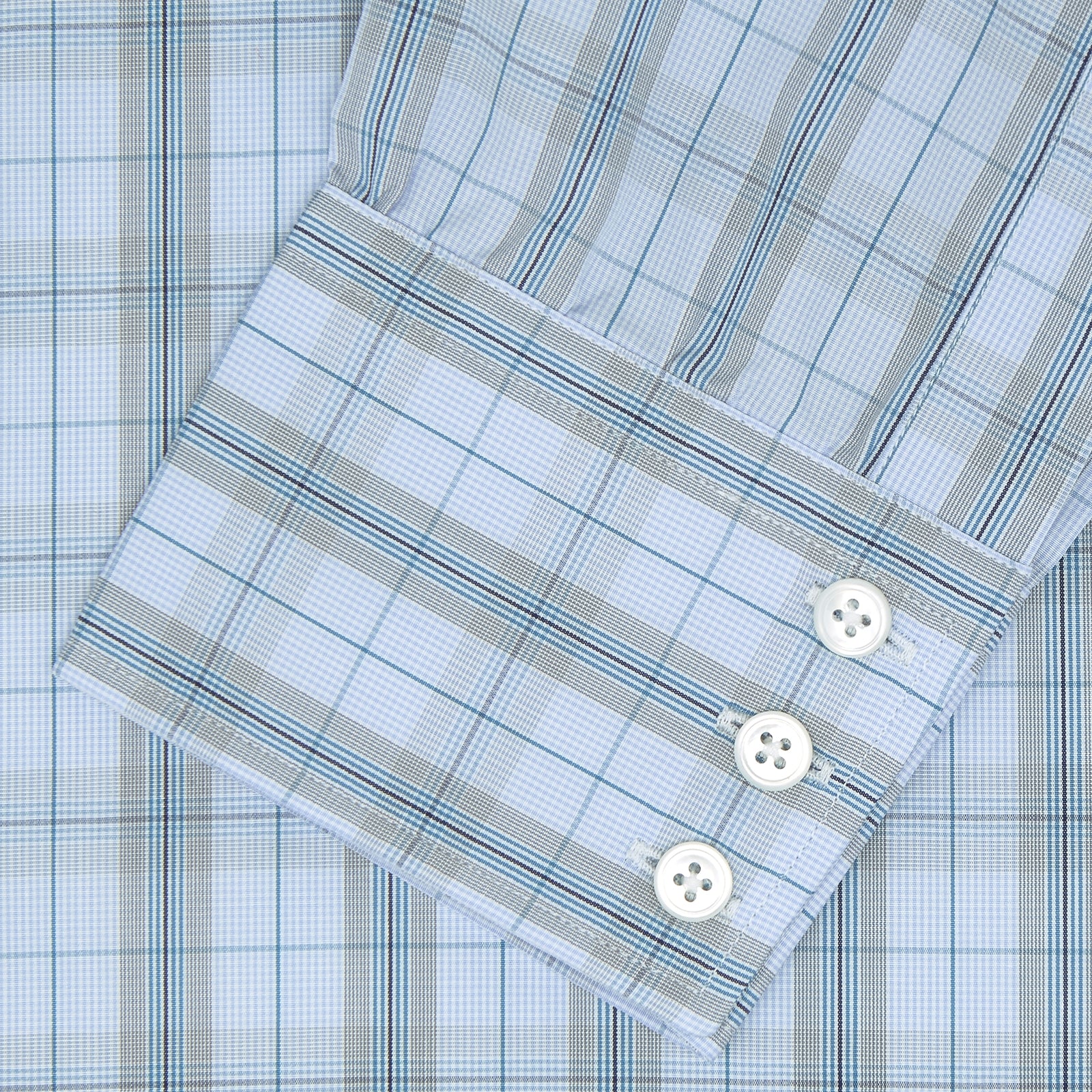 View 2 of product A neatly folded Turnbull & Asser Grey, Turquoise and Sky Blue Mixed Check Shirt with T&A collar and 3-button cuffs is displayed on a plain white background.