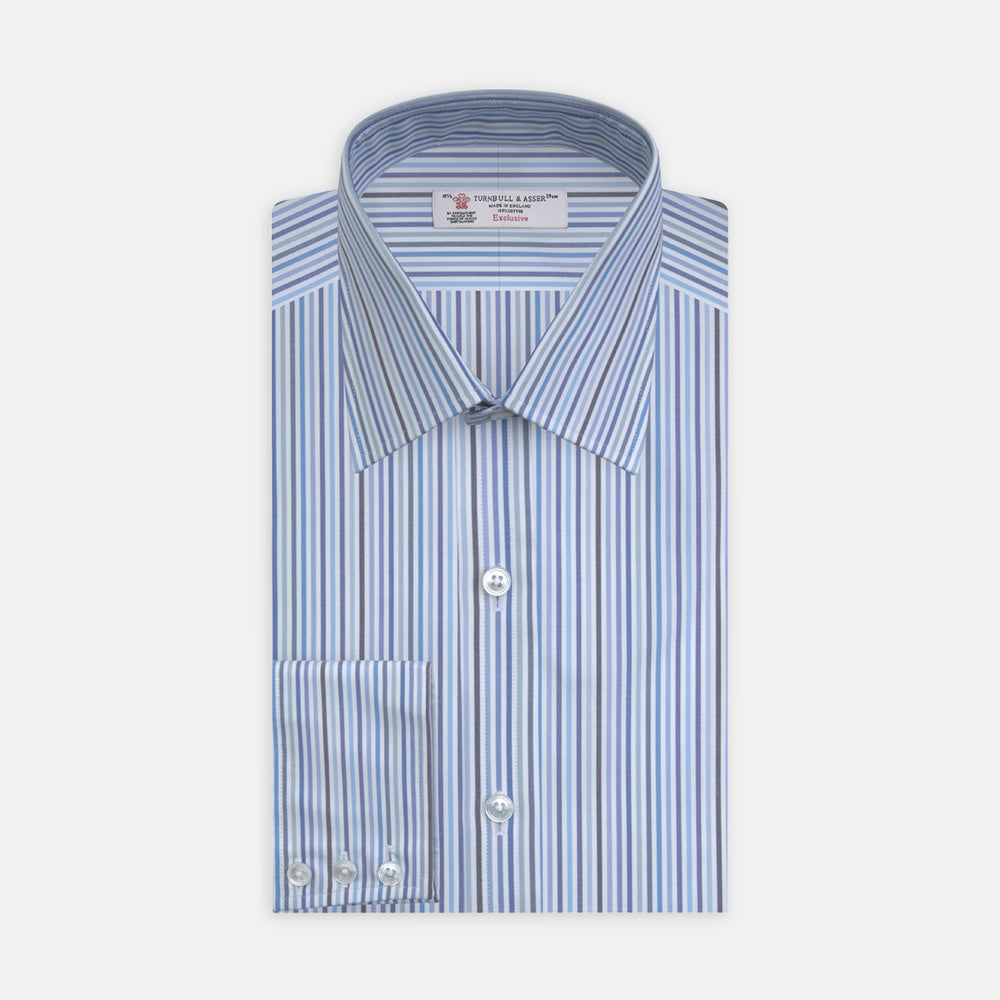 The Turnbull & Asser Blue and White Graph Stripe Shirt features a T&A collar, 3-button cuffs, and crisp vertical stripes, exemplifying refined bespoke tailoring. Displayed neatly folded on a plain light background.