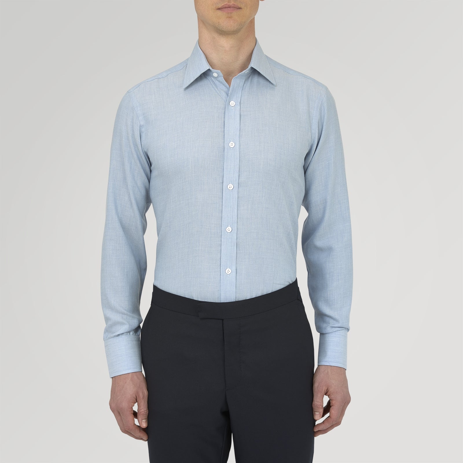 View 2 of product The Turnbull & Asser Blue Cashmere Blend Shirt features a T&A collar and 3-button cuffs, elegantly folded and showcased against a plain white background.
