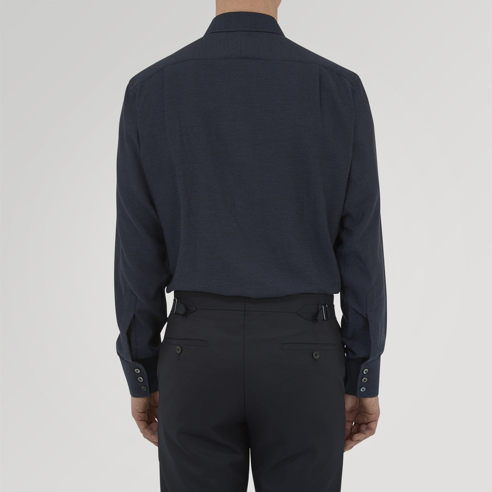 A navy cashmere blend Turnbull & Asser shirt with a T&A collar and 3-button cuffs, neatly folded and displayed against a plain white background.