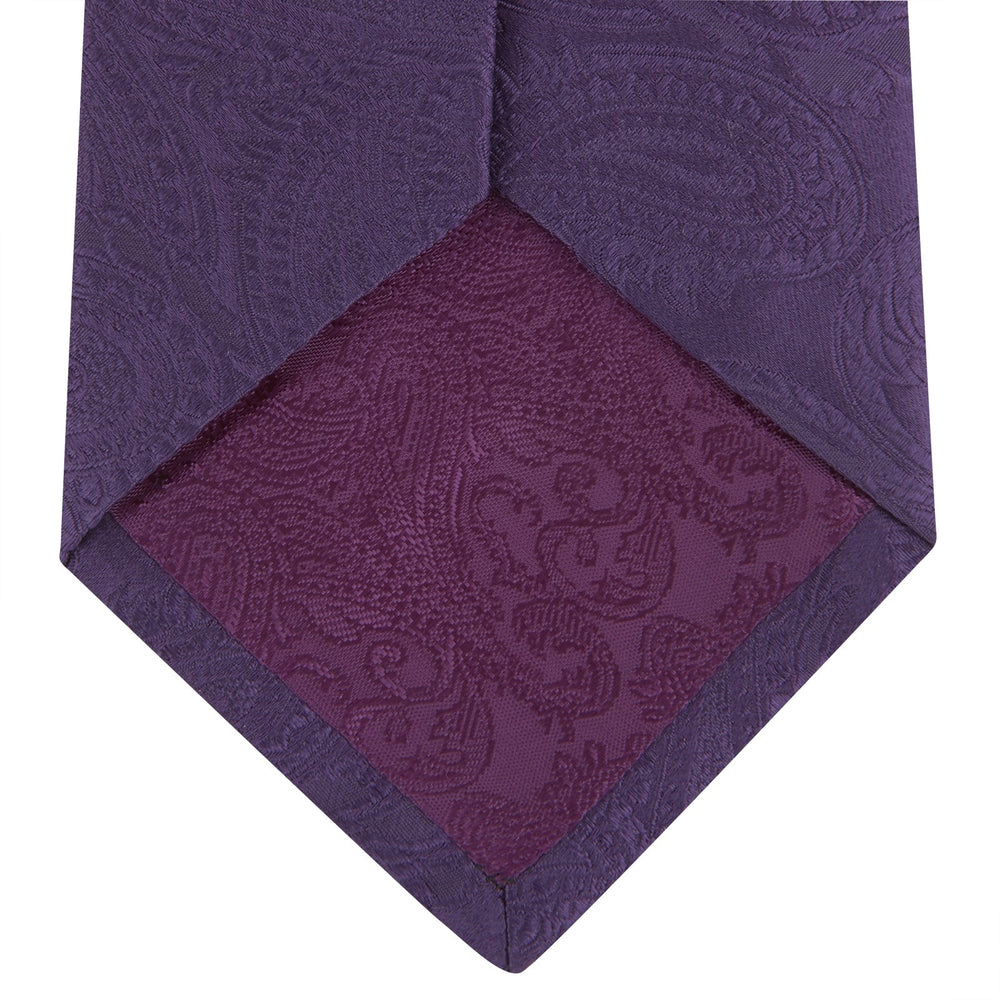 The Turnbull & Asser Purple Paisley Silk Tie, shown rolled on a white background, features an elegant paisley design—a stylish statement piece for any occasion.