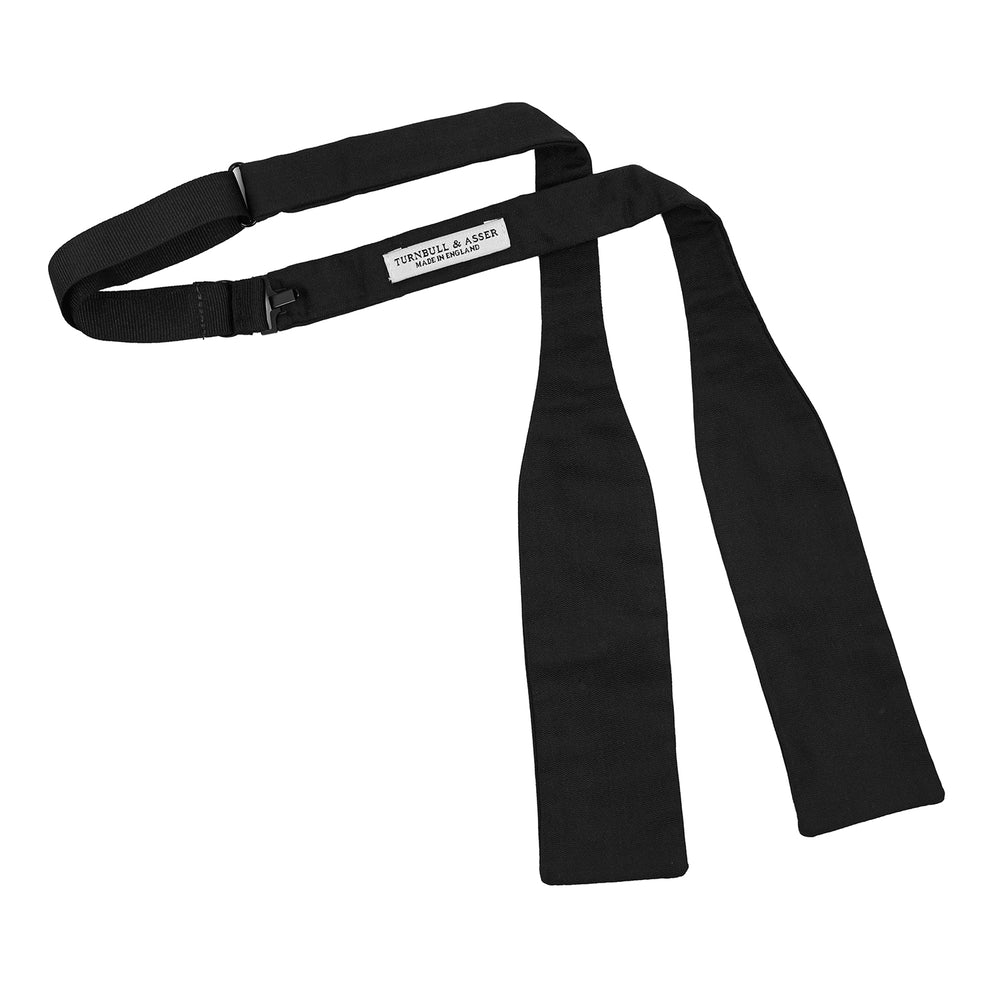 The Black Narrow Silk Bow Tie by Turnbull & Asser features a classic slim design with a matte finish, neatly tied and centered on a plain white background—perfect for formal occasions.