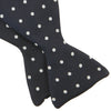 View 4 of product The Winston Navy and White Spot Silk Bow Tie by Turnbull & Asser features classic white polka dots on navy silk, reminiscent of Winston Churchill's style, and is shown against a plain white background.