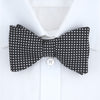 View 2 of product The Turnbull & Asser Diamond Black and White Silk Bow Tie features a black woven silk design with a tessellated diamond pattern of small white shapes, shown against a plain white background.